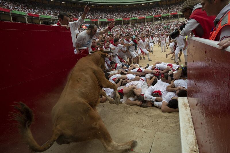 A heifer jumps over revellers in the bullring during the second day of the San Fermin Running of the Bulls festival in Pamplona, Spain. Getty Images