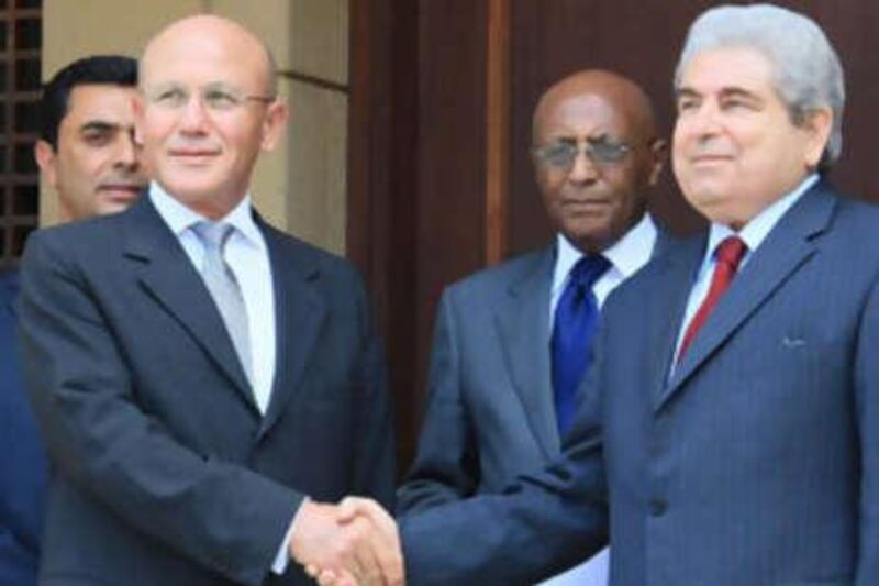 President Demetris Christofias, right, shakes hands with the Turkish Cypriot leader Mehmet Ali Talat at the residence of the UN Secretary-General's Special Representative in Cyprus on July 25.