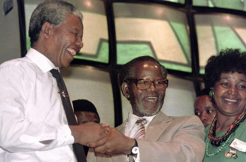 December 14, 1990: African National Congress (ANC) President Oliver Tambo (C), ANC deputy president Nelson Mandela (L) and Winnie Mandela (R) attend Tambo’s first ANC conference in South Africa after 30 years in exile in Soweto. Mandela in 1952 opened the first black law practice in Johannesburg with Oliver Tambo. Trevor Samson / AFP Photo
