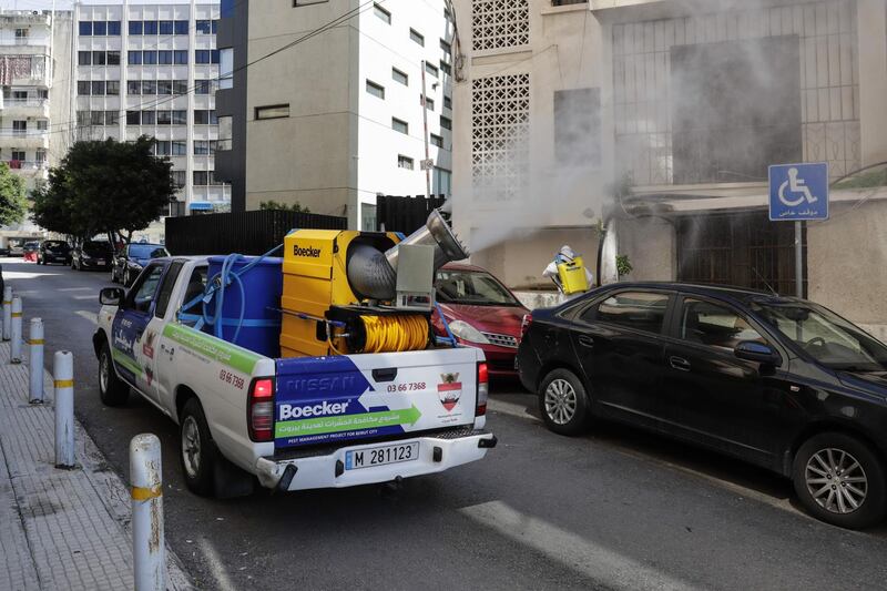 Municipality workers spray disinfectant in the Lebanese capital Beirut to prevent the spread of coronavirus (COVID-19), on March 22, 2020.  Lebanon called in the army and security forces to ensure people stay at home to slow the spread of the novel coronavirus that has killed four people nationwide. / AFP / ANWAR AMRO
