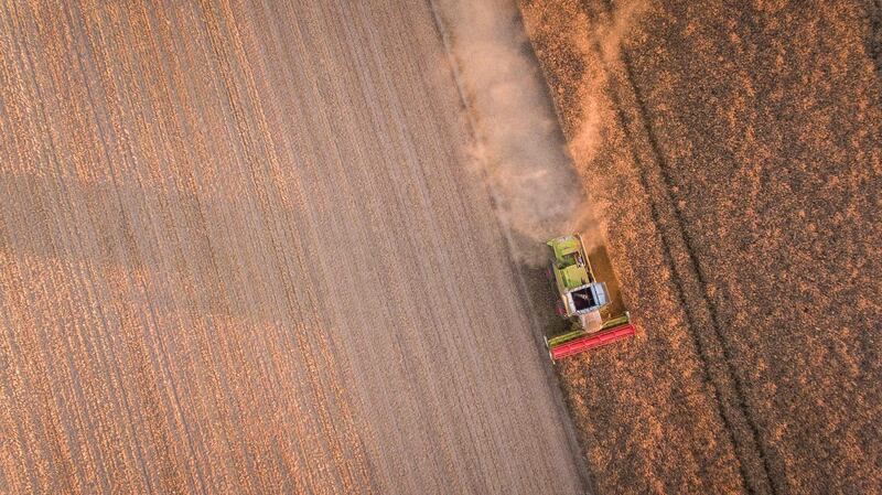 (FILES) This aerial file photo taken on July 5, 2017 shows a  combine harvester during a rape harvest  near Monthodon, central France. 
Chinese investors acquired 900 hectares of land in Alliers due to a judicial breach and may jeopardize the traditional family farming model in France.  / AFP PHOTO / GUILLAUME SOUVANT
