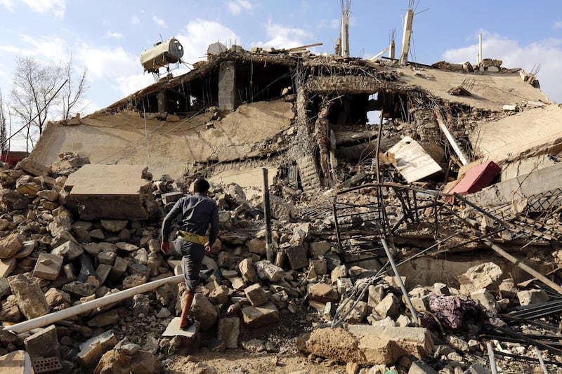 A Yemeni walks through debris of a destroyed building allegedly hit by a previous Saudi-led airstrike, in Sana'a. EPA