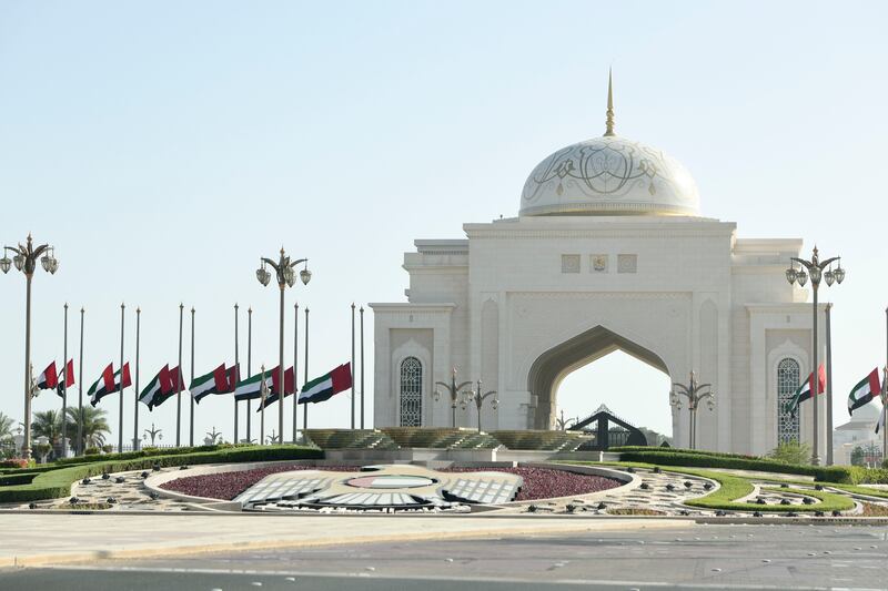 Flags fly at half-staff at the entrance to the Presidential Palace of Qasr Al Watan in Abu Dhabi after the death of President Sheikh Khalifa. Khushnum Bhandari / The National
