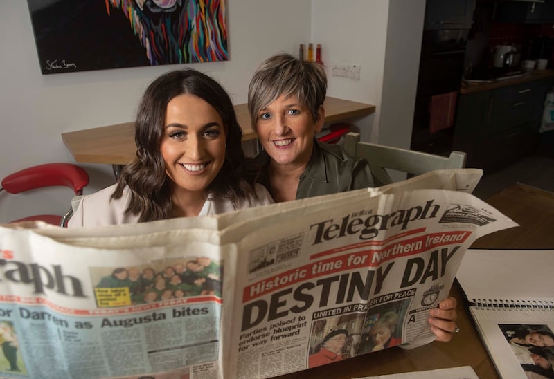 Erin McArdle, left, who was born on April 10, 1998, and her mother Caroline, hold The Telegraph which was published on the same day, at her home in Ballymena in Northern Ireland. EPA