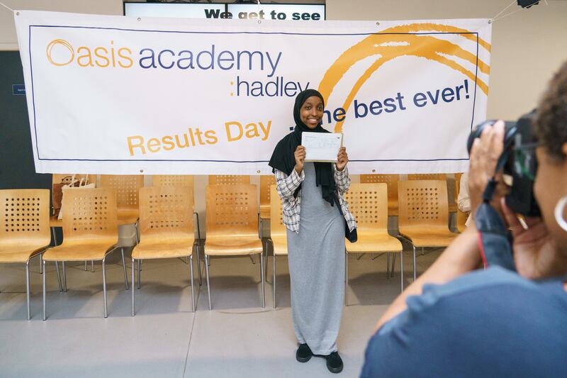 Yasmin Adan poses for a photo after receiving her results at Oasis Academy Hadley in north London. PA
