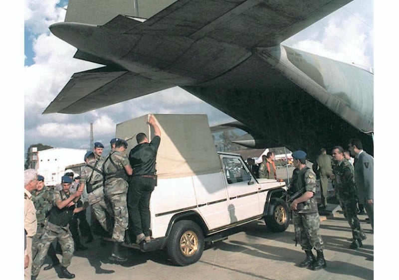 Under tight security, Lebanese soldiers unload Pope John Paul II's  "Popemobile" from an Italian military plane upon its arrival at Beirut airport, 03 May. The vehicule arrived one week ahead of the Pointiff, who will make a historical visit to Lebanon 10 and 11 May. (Photo by RAMZI HAIDAR / AFP)