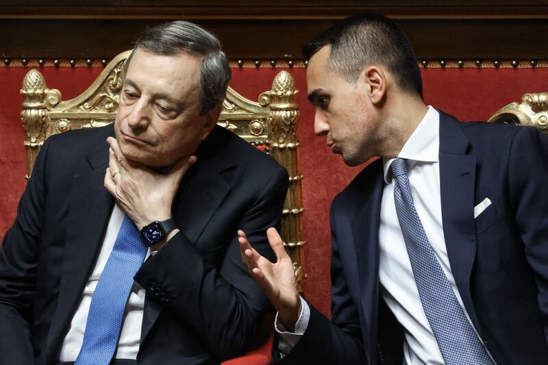 Mario Draghi, Italy's prime minister, left, and Luigi Di Maio, Italy's foreign affairs minister, talk during a debate at the Senate in Rome, Italy, on Tuesday, June 21, 2022.  Italy’s biggest party is set to splinter over the country’s support for Ukraine, just as Draghi defended in parliament his government’s stance on the conflict. Photographer: Alessia Pierdomenico / Bloomberg