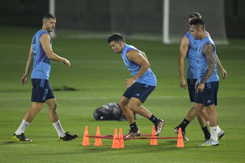 Argentina's Guido Rodriguez, Marcos Acuna and Lautaro Martinez attend a training session at Qatar University in Doha. AFP