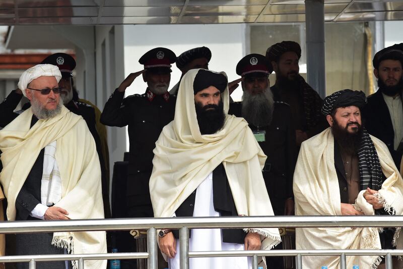 Haqqani and deputy prime minister of the Taliban, Abdul Salam Hanafi, left, attend the ceremony.  AFP