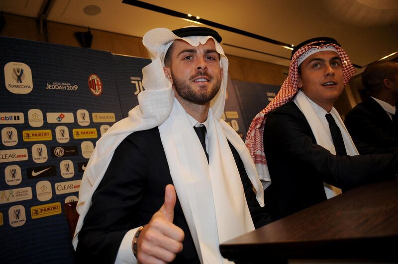 Miralem Pjanic and Paulo Dybala of Juventus wear the ghutra at the Juventus SELA sponsor event in Jeddah on Monday. Photo: Getty