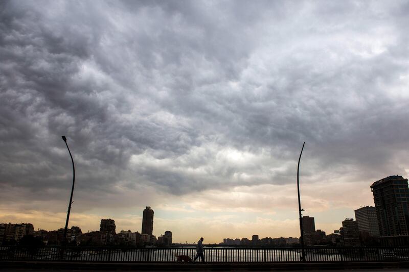 A man walks with his dog during a cloudy day in Cairo, Egypt. EPA