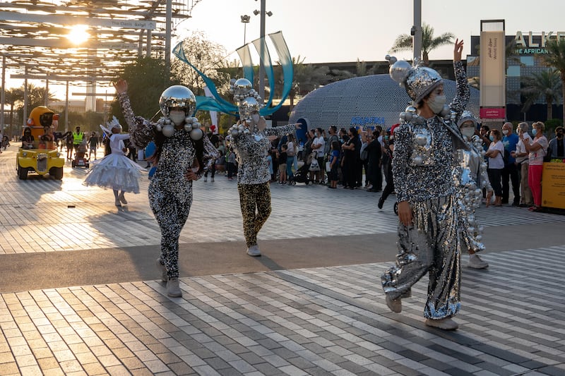 Performers dressed as silver baubles.