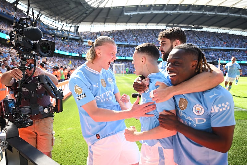 Phil Foden of Manchester City celebrates scoring his team's first goal with teammates. Getty Images