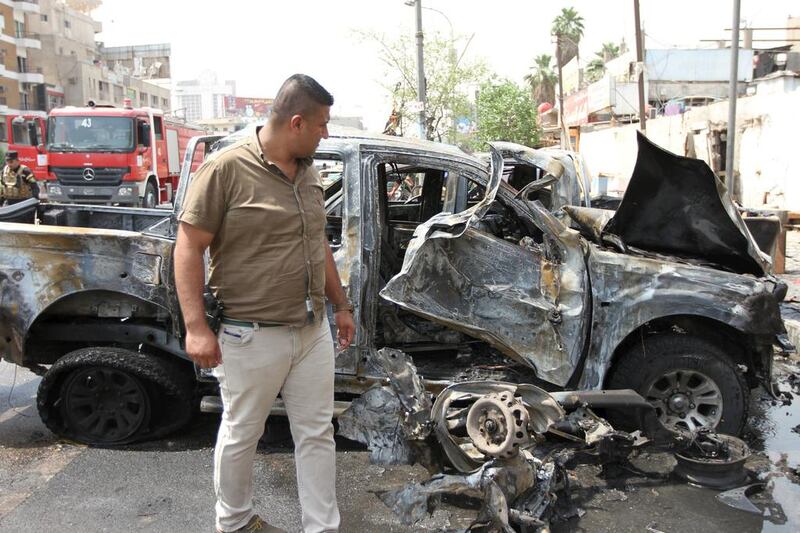 A member of Iraq’s security forces looks at the site of a car bomb attack in Baghdad’s Karrada district on May 9, 2015. Reuters