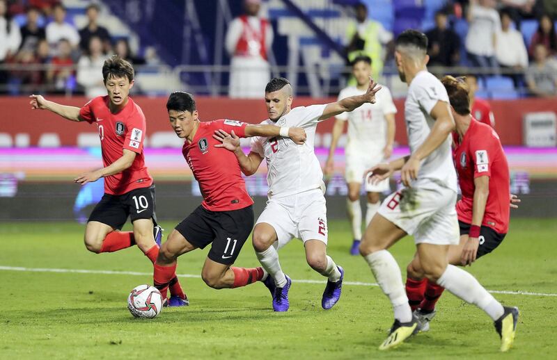 DUBAI , UNITED ARAB EMIRATES , January  7 – 2019 :- Hwang Heechan ( no 11 in red ) of Korea Republic and Alvaro Silva ( no 2 in white ) of Philippines in action during the AFC Asian Cup UAE 2019 football match between KOREA REPUBLIC vs. PHILIPPINES held at Al-Maktoum Stadium in Dubai. Korea Republic won the match by 1-0. ( Pawan Singh / The National ) For News/Sports