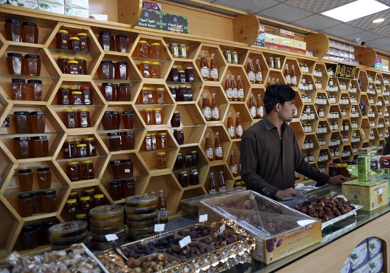 An Afghan shopkeeper sells dates and honey during the Muslim holy month of Ramadan, in Kabul, Afghanistan, Tuesday, June 5, 2018. Ramadan is marked by daily fasting from dawn to sunset and an increase of good deeds and charity. (AP Photo/Rahmat Gul)