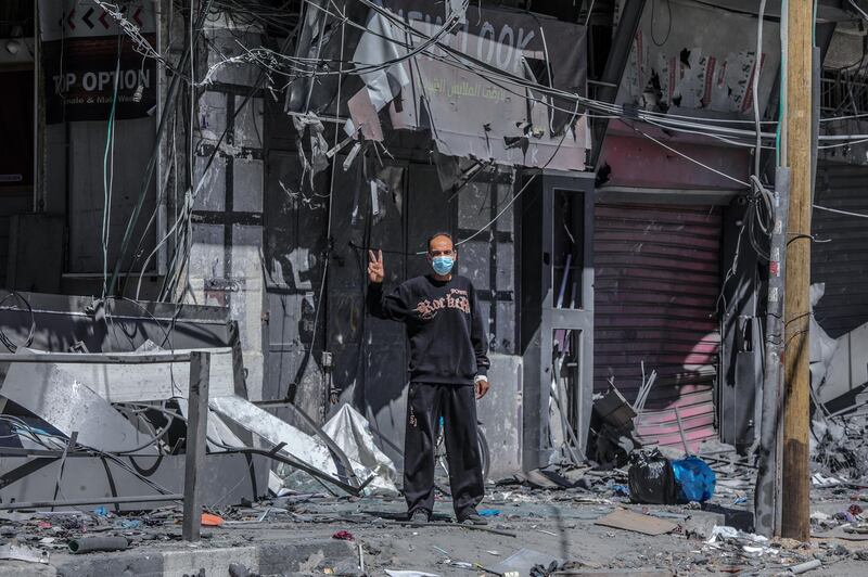 A Palestinian man stands next to his destroyed house after Israeli air strikes in Gaza city. EPA