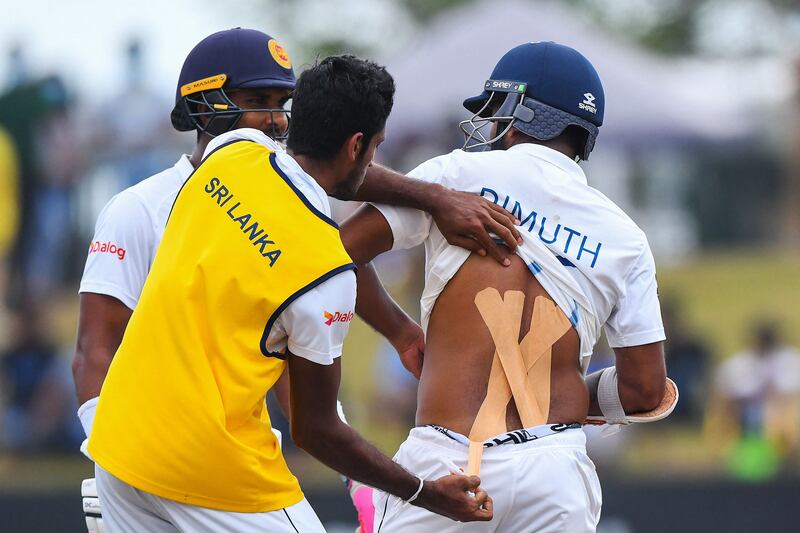 Dimuth Karunaratne gets treatment on his back on Tuesday. AFP