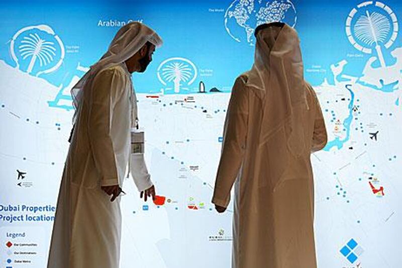 Visitors study a map at the Dubai Properties Group stand on the first day of Cityscape.