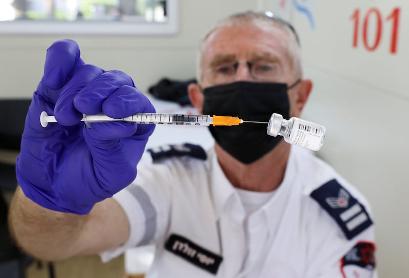 A health worker prepares a vaccine against Covid-19, as Israel continues to fight against the spread of the Delta variant, in Tel Aviv.