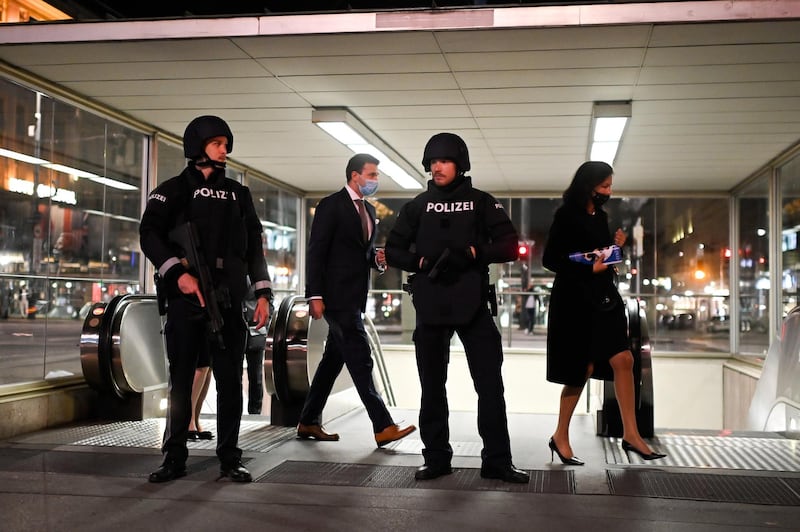 Austrian police guard visitor of The Wiener Staatsoper (Vienna State Opera) while they leave a metro station following gun attacks in the capital.  EPA