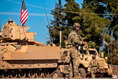 A US soldier stands by a Bradley Fighting Vehicle during a patrol in the countryside near Al Malikiyah in Syria's north-eastern Hasakah province on February 2, 2021. AFP
