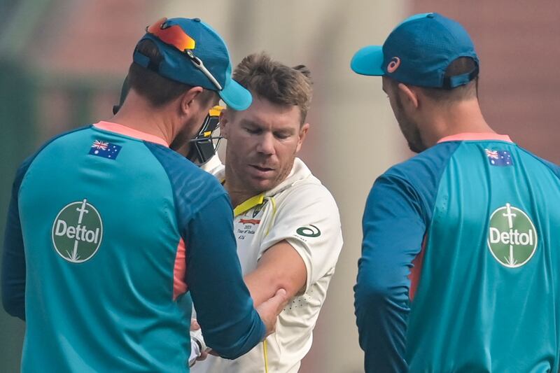 Australia's David Warner gets medical attention during the first day of the second Test against India in Delhi. AFP