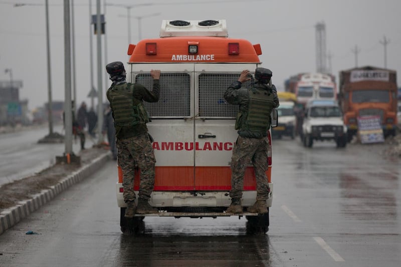 Indian paramilitary soldiers hang on to an ambulance carrying bodies of their colleagues near the site of an explosion in Pampore, Indian-controlled Kashmir. Security officials say at least 10 soldiers have been killed and 20 others wounded by a large explosion that struck a paramilitary convoy on a key highway on the outskirts of the disputed region's main city of Srinagar. AP Photo