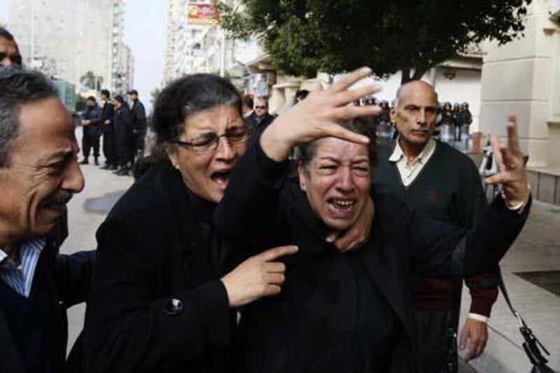 Egyptian Christian women mourn on January 2, 2011 upon their arrival at the Al-Qiddissine (The Saints) church in Alexandria for Sunday mass, following a New Year's Eve car bomb attack on the Coptic church in the northern Egyptian Mediterranean port in which 21 people were killed. Egyptian newspapers warned on Sunday that "civil war" could break out unless Christians and Muslims close ranks after the deadly attack on the Coptic church that triggered angry protests. AFP PHOTO/MOHAMMED ABED


