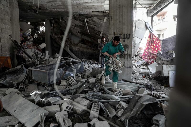 A Syrian man inspect a hospital, damaged following an air strike a rebel-controlled town in the eastern Ghouta region on the outskirts of the capital Damascus on May 1, 2017. (Photo by Sameer Al-Doumy / AFP)