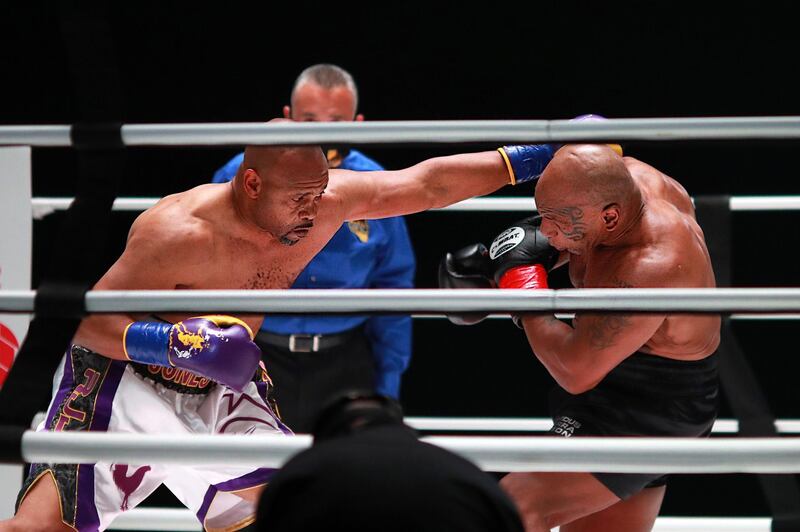 Roy Jones Jr. (L) throws a punch in the second round against Mike Tyson. AFP
