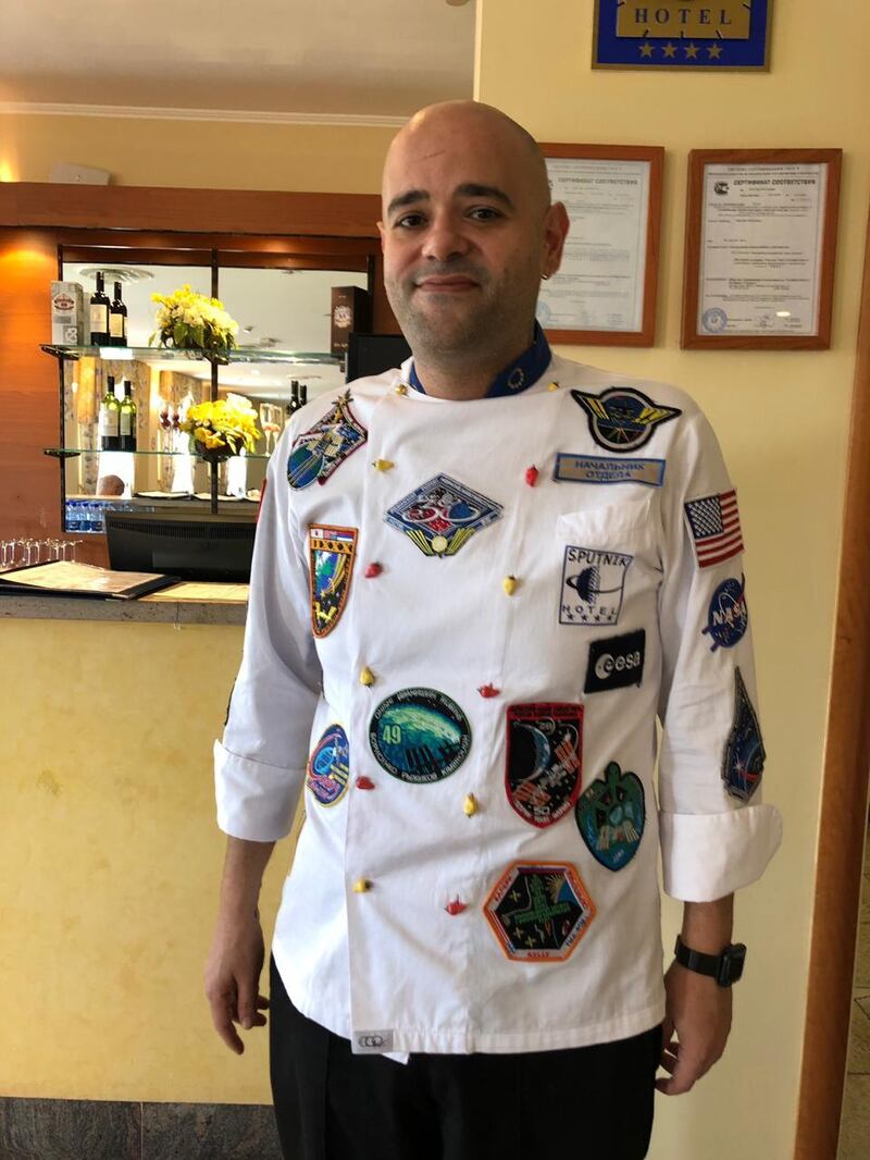 Hassan Yehia, from Lebanon, is a chef at the Sputnik Hotel in Baikonur. His uniform is space themed. Erica Alkhershi / The National