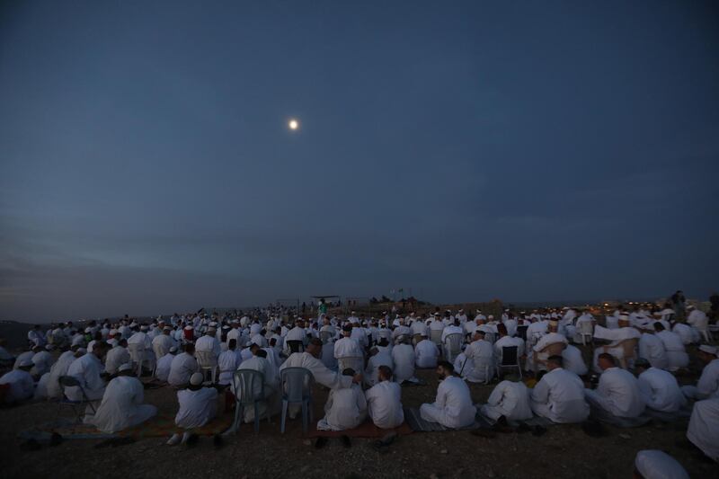 Members of the Samaritan community pray at sunrise during a religious service marking the end of their Passover holiday atop Mount Gerizim, in the West Bank town of Nablus. EPA