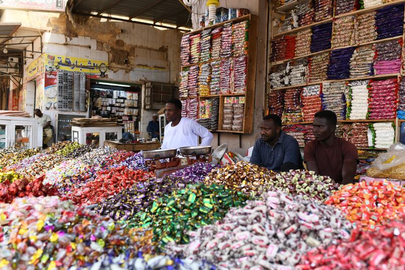 Market vendors wait for customers. EPA 