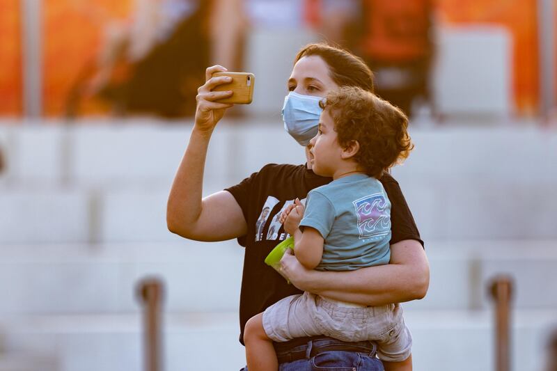 An Expo 2020 visitor takes a picture at Jubilee Park on World Children’s Day.