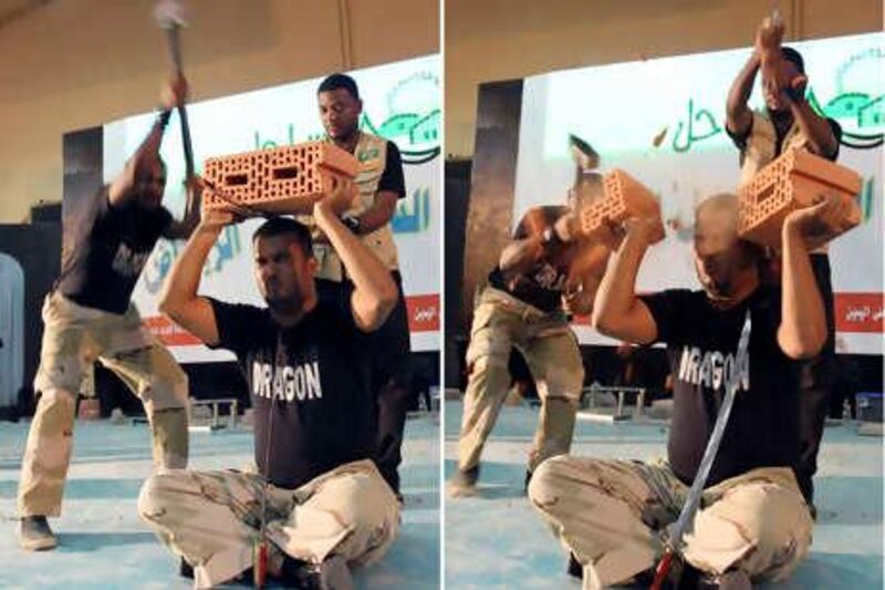 A combination photo shows martial arts performers of the Dragon show team breaking bricks during a public performance in Riyadh July 16, 2010. The Senior Ulema Council, a regulatory body of religious leaders, in response to the media's sensationalizing of such stunts as "supernatural acts", has called for a ban this week on these acts which they say are "dupery and sorcery" and are "illegal ways to make a living", according to local reports. REUTERS/Fahad Shadeed (SAUDI ARABIA - Tags: SOCIETY IMAGES OF THE DAY)