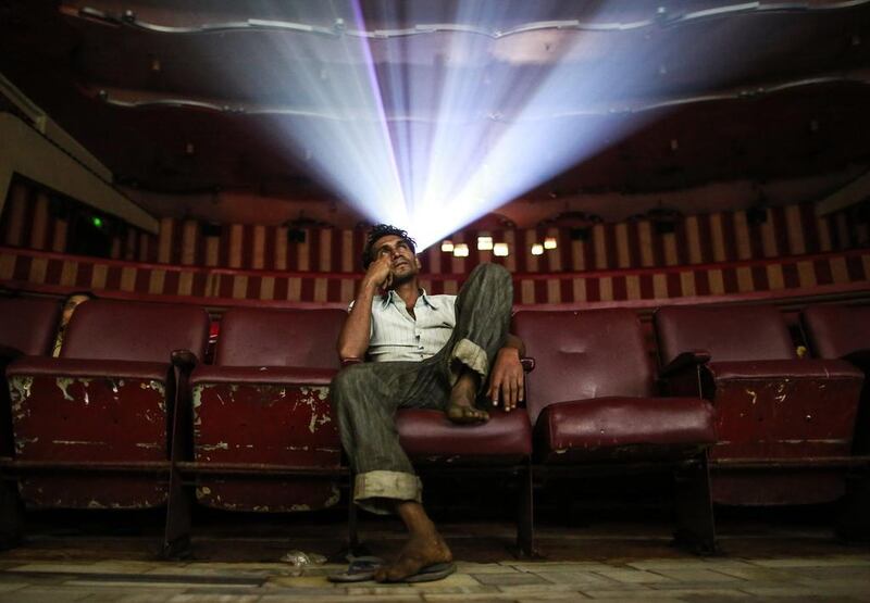 A cinema goer watches Bollywood movie "Dilwale Dulhania Le Jayenge" (The Big Hearted Will Take the Bride), starring actor Shah Rukh Khan, inside the Maratha Mandir theatre in Mumbai, India. Danish Siddiqui / Reuters
