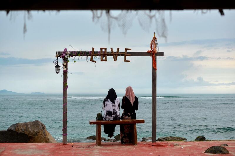 People gather at a cafe which reopened for visitors along a beach at Lhoknga, Aceh province.   AFP