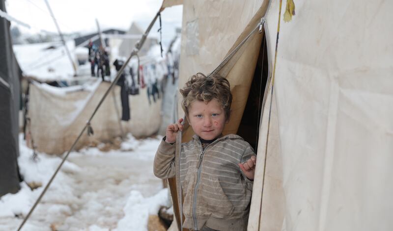 A child peers out of a tent at Salat Zagrous Camp for internally displaced Syrians in Afrin, Aleppo Governorate. A strong snowstorm and torrential rain hit several camps of internally displaced people in north-western Syria on Wednesday, causing roadblocks, destroying hundreds of tents and forcing dozens of families to abandon the area. All photos: EPA
