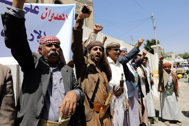 epa06675338 Armed Houthi supporters shout slogans during a protest against the US, France, and Britain offensive against Syria, outside the Syrian embassy in Sana'a, Yemen, 17 April 2018. According to reports, armed Houthi supporters gathered outside the Syrian embassy in Sana'a to protest after the US, France, and Britain launched strikes against Syria on 14 April in response to Syria's suspected chemical weapons attack.  EPA/YAHYA ARHAB
