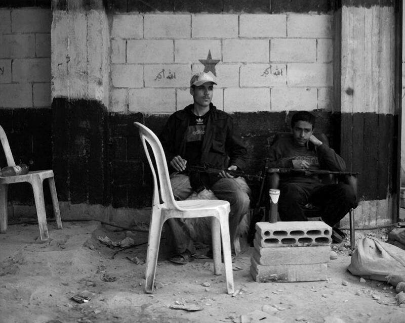 Men wait at a checkpoint in Homs in 2012. Courtesy Phil Sands