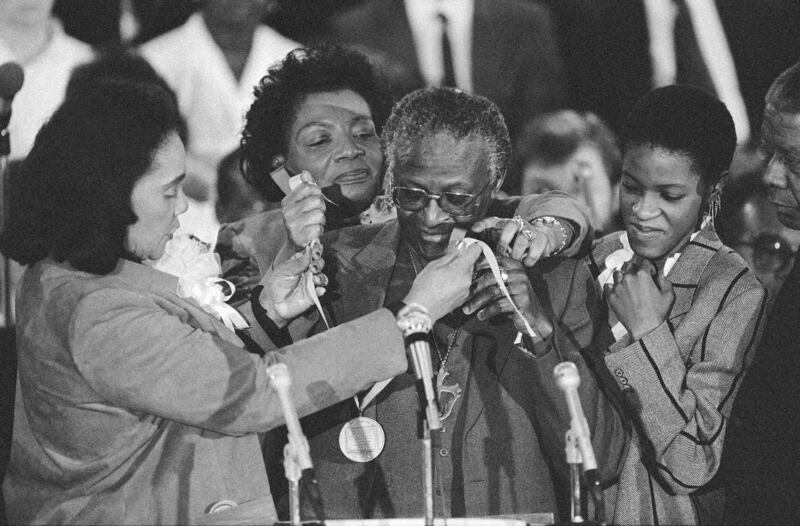 Tutu receives the Martin Luther King Jr Peace Prize from Coretta Scott King, left, and Christine King Farris, King's sister, centre, during an ecumenical service at the Ebenezer Baptist Church, where King was pastor in Atlanta, Georgia, in 1986. AP