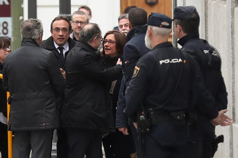 Catalan politician Jordi Turull (C) embraces his wife Blanca Bragulat as he arrives to the Supreme Court after being summoned and facing investigation for his part in Catalonia's bid for independence in Madrid, Spain, March 23, 2018.  REUTERS/Susana Vera