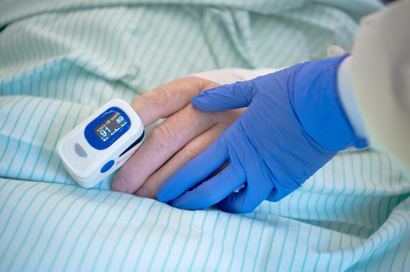 AACHEN, GERMANY - APRIL 09: Medical staff wearing protective gloves measures the oxygen in the blood of an patients with coronavirus (COVID-19) at an regular station of Aachen University Hospital on April 9, 2020 in Aachen, Germany. While the number of cases of Covid-19 infection is continuing to rise in Germany, the rate has slowed to a current doubling rate of over 14 days, giving many people hope that restrictions on public and commercial life imposed by authorities as a means to slow the spread of the coronavirus are having a significant effect. (Photo by Sascha Schuermann/Getty Images)