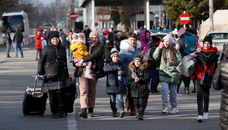 Ukrainian refugees cross the Romanian border at Siret, northern Romania. EPA