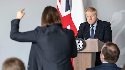 British Prime Minister Boris Johnson takes a question from Ukrainian journalist Daria Kaleniuk about the no-fly zone as he gives a press conference in Warsaw