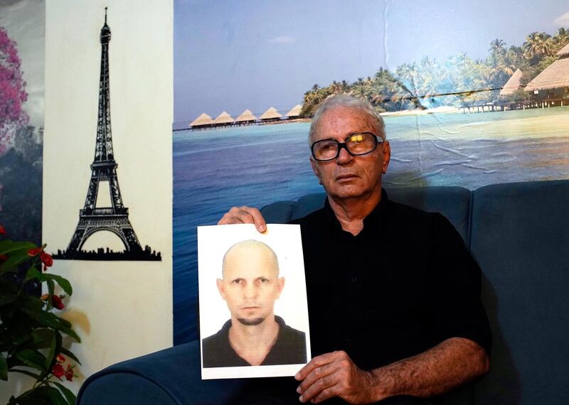 Nelson Faria Marinho shows a picture of his son Nelson Marinho, who lost his life in the 2009 Air France flight 447 accident, during an interview at his home in Rio de Janeiro, Brazil, Thursday, Sept. 5, 2019. French judges dropped a decade-long investigation into Air France and planemaker Airbus over the 2009 crash of a flight from Rio de Janeiro to Paris, which killed all 228 people aboard and led to new aircraft safety regulations. (AP Photo/Silvia Izquierdo)
