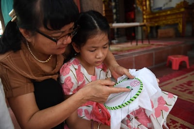 A child learns embroidery during a lesson in Hanoi on July 19, 2022.  Photo: AFP