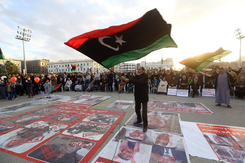Demonstrators wave flags and step on posters of some world leaders as they take part in a rally against eastern Libyan strongman Khalifa Haftar and in support of the UN-recognised government of national accord (GNA) in Martyrs' Square in the GNA-held capital Tripoli.  AFP