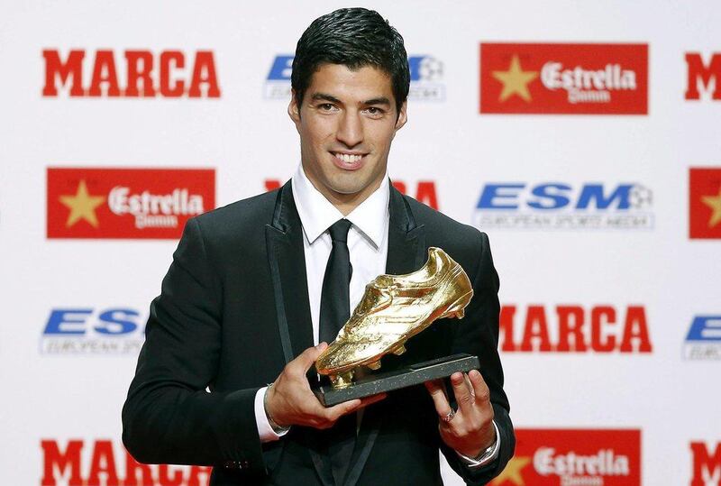 Luis Suarez poses with his Golden Boot award on Wednesday as the joint top scorer in Europe with Cristiano Ronaldo for the 2013/14 European league season. Andreu Dalmau / EPA / October 15, 2014